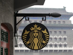 The Starbucks logo is seen outside its coffee store in front of Zhengyangmen Gate at Qianmen Commercial Street in central Beijing, in this April 19, 2012 file photo. Starbucks Corp, the world's largest coffee chain, said on January 12, 2016 it aims to open 500 stores in China this year, shrugging off a slowdown in the world's second-largest economy that has hit global retailers. (REUTERS/Jason Lee/Files)