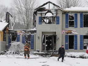 Investigators search a house explosion in Northfield Center Township, Ohio, on Jan. 12, 2016. (AP Photo/Tony Dejak)