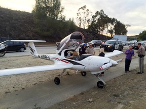 This Monday, Jan. 11, 2016 photo provided by the Ventura County Fire Department shows a two seat airplane after it made an emergency landing on the State Route 23 Freeway in Moorpark, Calif. The California Highway Patrol says vehicles had to swerve to avoid hitting the two-seat aircraft when it touched down after the engine began to sputter. No one was injured.(Ventura County Fire Department via AP)