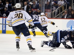 Winnipeg Jets' Mathieu Perreault (85) appeared to get hurt while playing against the Buffalo Sabres' during second period NHL hockey action in Winnipeg, Sunday, January 10, 2016.