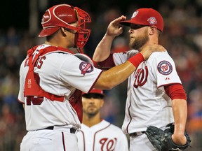 Washington Nationals catcher Wilson Ramos talks with relief pitcher Drew Storen during a game against the New York Mets at Nationals Park in Washington on Sept. 8, 2015. (AP Photo/Alex Brandon)