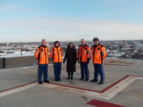 Health Minister Sharon Blady (centre) stands with a STARS air ambulance crew -- Dave Harding (left), Sarah Painter, Ray Rempel and Paul Adams, to announce that the helipad at Winnipeg's Health Sciences Centre will open soon. Jan. 12, 2015.