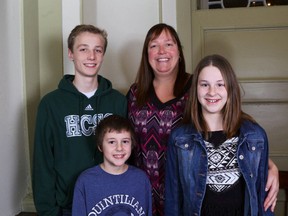Mary Jane Besselink, one of five new inductees in the Kingston & District Sports Hall of Fame, is flanked by her children, from left, Emmett, Tim and Isabelle Bravakis, at City Hall on Monday night. (Ian MacAlpine/The Whig-Standard)