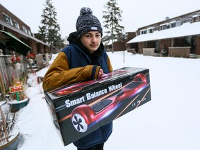 15-year-old Jeffrey Lattreille holds the empty box for the "hover board" where he had it stolen at knife point in Ottawa. Tuesday January 12, 2016. Errol McGihon/Ottawa Sun/Postmedia Network