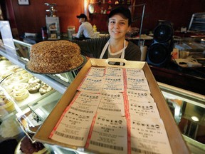 Ayshe Panulku with a cake and a tray of Powerball tickets at World Class Bakers, on St. Clair Ave. W., near Bathurst St., Monday, January 11, 2016. (Craig Robertson/Toronto Sun)