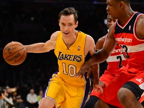 Steve Nash (10) of the Los Angeles Lakers drives against Kevin Seraphin and John Wall of the Washington Wizards during their NBA game on March 22, 2013 in Los Angeles. (AFP PHOTO/Frederic J. BROWN)