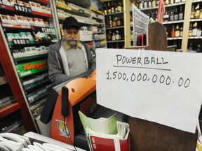 Baldev Singh, owner of the Mini Mart in St. Joseph, Mich., handles a Powerball lottery ticket purchase Tuesday, Jan. 12, 2016. The Powerball lottery jackpot has risen to over one billion dollars with the next drawing occurring Wednesday night. (Don Campbell/The Herald-Palladium via AP)