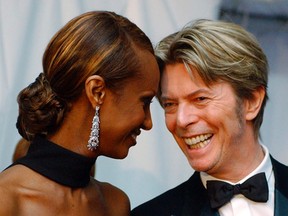 In this June 3, 2002, file photo, Iman, left, and her husband, singer David Bowie arrive at the Council of Fashion Designers of America Fashion Awards in New York. (AP Photo/Suzanne Plunkett, File)