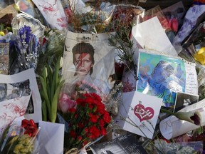 Tributes to the late British singer David Bowie are seen at a makeshift memorial outside his home in the Manhattan borough of New York City, January 13, 2016.   REUTERS/Shannon Stapleton        FOR EDITORIAL USE ONLY. NO RESALES. NO ARCHIVE.