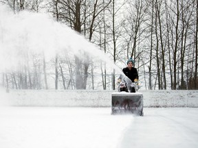 Carter Grace, the outdoor rink supervisor at Robinson Playground, clears the rink of snow in anticipation of its opening this evening in Sudbury, Ont. on Tuesday January 12, 2016. Gino Donato/Sudbury Star/Postmedia Network