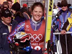 Picabo Street smiles in the finish area of the Olympic women’s downhill course at Snowbasin, February 9, 2002. (REUTERS/Leonhard Foeger)