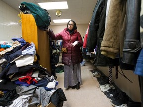 Afshan Rais, a volunteer with the Salam Community Donation Centre, shows some of the men's and boys' clothing donated by the community for newly arrived Syrian refugees, at their collection centre at 797 York Street in London, Ont. on Wednesday January 13, 2016. One of the biggest needs is baby supplies, says Rais. (CRAIG GLOVER, The London Free Press)