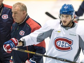Montreal Canadiens head coach Michel Therrien skates past Alex Galchenyuk during practice Wednesday, January 13, 2016 in Brossard, Que. (THE CANADIAN PRESS/Paul Chiasson)
