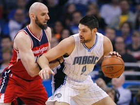 Washington Wizards centre Marcin Gortat (left) defends Orlando Magic centre Nikola Vucevic (9) during the first quarter at Amway Center. (Reinhold Matay/USA TODAY Sports)