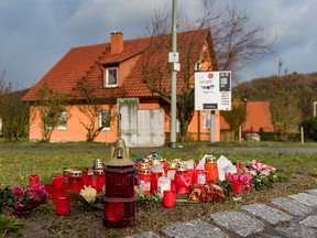 Candles and flowers are placed in Oberauchrach, near Bamberg, Germany, Wednesday Jan. 13, 2016.   (Nicolas Armer/dpa via AP)