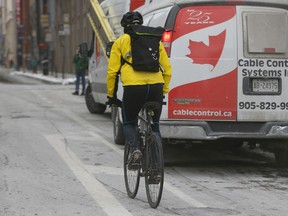 Cyclist Rich Sanchez is all alone along Richmond St. W. in Toronto on Wednesday, January 13, 2016. (Jack Boland/Toronto Sun)