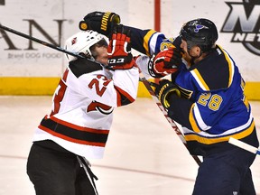 St. Louis Blues centre Kyle Brodziak (right) fights with New Jersey Devils winger Bobby Farnham during the third period at Scottrade Center. (Jasen Vinlove-USA TODAY Sports)