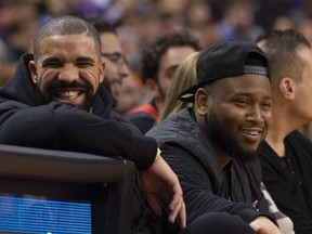 Rapper Drake smiles as he attends a Toronto Raptors NBA game against the Golden State Warriors in Toronto on Dec. 5 , 2015. (THE CANADIAN PRESS/Chris Young)