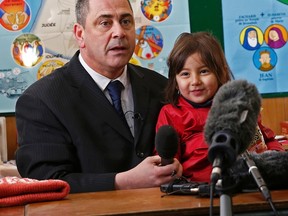 Ex-soldier Rob Lawrie attends a news conference with Afghani girl Bahar Ahmadi, known as Bru, in Boulogne-sur-Mer, France, on Jan. 14, 2016. Lawrie goes on trial in France on Thursday for trying to smuggle a four-year-old Afghan girl into Britain at her father's request. (REUTERS/Benoit Tessier)