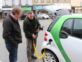Jay Heaman shows Tillsonburg mayor Stephen Molnar the adaptor and extension pack that can turn a 120 V outlet into a makeshift electric car charging station. It takes 20 hours to fully charge an electric car's battery from a regular outlet. (MEGAN STACEY, Sentinel-Review)