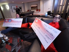 The Dream Home Lottery 50/50 Plus winner Mark Allott, left, and grand prize winner Glenn Nielsen, right, kick up their feet in the basement of the dream home in London, Ont. on Thursday January 14, 2016. Nielsen chose to take the $1 million prize, which he will use to buy his nephew and niece new cars, along with a Collingwood condo for he and his family to use year round. (CRAIG GLOVER, The London Free Press)