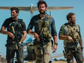 In this photo provided by Paramount Pictures shows Pablo Schreiber, from left, as Kris "Tanto" Paronto, John Krasinski as Jack Silva, David Denman as Dave "Boon" Benton and Dominic Fumusa as John "Tig" Tiegen, in the film, "13 Hours: The Secret Soldiers of Benghazi" from Paramount Pictures and 3 Arts Entertainment/Bay Films. The movie releases in U.S. theaters Jan. 15, 2016. (Christian Black/Paramount Pictures via AP)