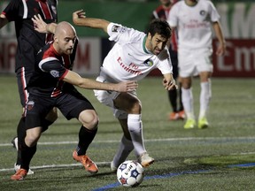 New York Cosmos' Raul (R) competes for the ball with Ottawa Fury's Jeremy Gagnon-Lazare during their NASL Championship Finals match in Hempstead, New York, November 15, 2015. REUTERS/Brendan McDermid