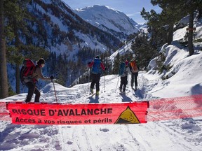 A  banner with the warning message, "Risk of Avalanche - Proceed at your own risk and peril" stretches across a ski trail in this picture taken on December 12, 2012 in Courcheval, France. An avalanche killed three people and seriously injured others when it swept into skiers, including a group of schoolchildren, on a closed slope in the French Alps January 13, 2016, the interior ministry said.  Picture taken December 12, 2012.  REUTERS/Emmanuel Foudrot