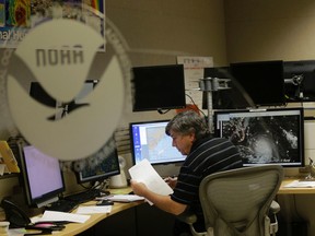 File photo of Jack Beven, senior hurricane specialist, monitoring the movement of Hurricane Joaquin in the eastern Bahamas, at the National Hurricane Center, Thursday, Oct. 1, 2015, in Miami. (AP Photo/Lynne Sladky/Files)