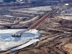 An oil sands facility seen from a helicopter near Fort McMurray, Alta., on July 10, 2012. Alberta's Crown-owned bank is predicting the first six months of this year will be the roughest yet in the current economic downturn. ATB Financial is forecasting the petroleum industry will continue to shed jobs, with Fort McMurray and Calgary taking the hardest hit. THE CANADIAN PRESS/Jeff McIntosh