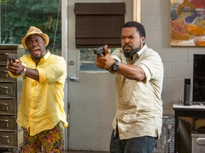 This photo provided by Universal Pictures shows, Kevin Hart, left, as Ben Barber and Ice Cube as James Payton in a scene from the film, "Ride Along 2." (Quantrell D. Colbert/Universal Pictures via AP)