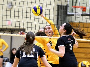 Toni Teale of the Cambrian Golden Shield tries to reach the ball as Chanelle Martin and Mélanie Leger of College Boreal look on during OCAA women's volleyball action from Cambrian College on Wednesday.