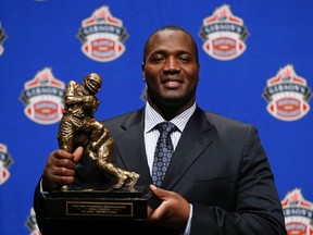 B.C. Lions’ Jovan Olafioye holds his trophy after being named Most Outstanding Offensive Lineman at the annual CFL player awards ahead of the 100th Grey Cup championship game in Toronto November 22, 2012. (REUTERS/Todd Korol)