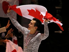 Patrick Chan of Canada holds his country’s flag after winning the gold medal in the men’s program at Skate Canada International in Lethbridge October 31, 2015. (REUTERS/Jim Young)