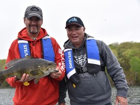 Local fishing guide Frank Clark (left) shows off a big smallmouth bass caught while shooting an episode of Bob Izumi's Real Fishing, that will air this Saturday on Global TV at 8:30 a.m.