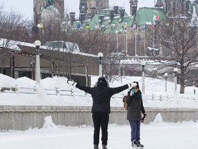 Skaters enjoy the Rideau Canal Skateway in Ottawa backdropped by the Parliament Buildings. February 25, 2015. Errol McGihon/Ottawa Sun files