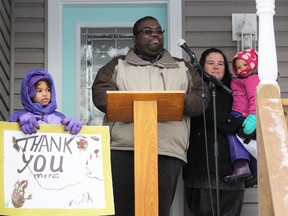 Devon Craig and his wife Danica thank a crowd of Habitat for Humanity Sarnia-Lambton partners as they receive keys to their new home Thursday afternoon. Nearly 150 Habitat volunteers -- including students from five city schools -- renovated a century home on Alfred Street in order for the Craig family to purchase it through the Habitat program. Pictured here with their parents are Ziya, 6, and Kreelyn, 2. (Barbara Simpson/Sarnia Observer/Postmedia Network)