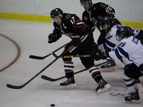 Sarnia Legionnaires captain Hunter Tyczynski tries to shake off a pair of pursuing London Nationals during the Greater Ontario Junior Hockey League game at Sarnia Arena on Thursday, Jan. 14, 2016 in Sarnia, Ont. The Legionnaires and Nationals faced off for the second time in as many nights. Terry Bridge/Sarnia Observer/Postmedia Network