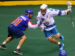 Bill Hostrawser (left) of the Toronto Rock checks Jordan Hall of the Rochester Knighthawks on Jan. 14. (Dave Abel, Toronto Sun)