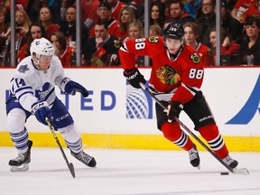 Chicago Blackhawks right winger Patrick Kane (88) right is defended by Toronto Maple Leafs defenceman Morgan Rielly (44) left during the first period of their NHL game at United Center in Chicago on Dec. 21, 2014. (KAMIL KRZACZYNSKI/USA TODAY Sports files)