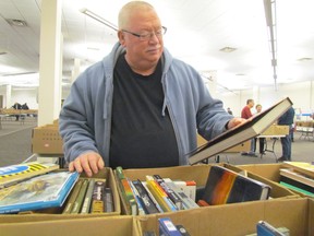 Wes Kershaw looks through boxes on Friday January 15, 2016 in Sarnia, Ont., at the Rotary Club of Sarnia Bluewater annual book sale. The sale continues Saturday and Sunday at the Bayside Centre.
Paul Morden/Sarnia Observer/Postmedia Network