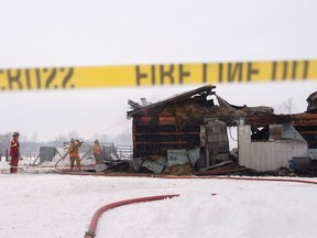 Firefighters continue to work on a barn fire in Mount Forest, Ont., on Jan. 15, 2016. At least 12 horses have died in a barn fire in the second such tragedy to hit southern Ontario this month. (THE CANADIAN PRESS/Hannah Yoon)