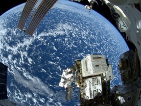 NASA astronaut Reid Wiseman and European Space Agency astronaut Alexander Gerst (not shown) works outside the space station's Quest airlock in the first of three spacewalks for the Expedition 41 crew aboard the International Space Station in this NASA image released October 8, 2014. REUTERS/NASA/Handout via Reuters