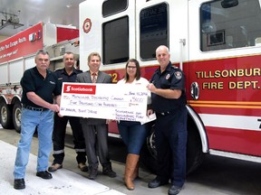 Tillsonburg firefighters and Scotiabank combined to contribute $5,100 to Muscular Dystrophy Canada. From left are MD Canada's John Boe, Tillsonburg captain Barry Lasook, Scotiabank's David Abrams, MD Canada's Carrie Gibson, and Tillsonburg firefighter Dave Metselaar, co-chair of the Tillsonburg Firefighters Association MD Canada committee with Lasook. (CHRIS ABBOTT/TILLSONBURG NEWS)