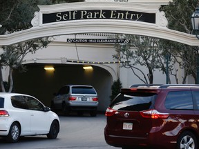 In this photo taken Thursday, Jan. 14, 2016, cars drive into the Bellagio hotel and casino in Las Vegas. Casino giant MGM Resorts International will announce Friday, Jan. 15,  that it plans to begin charging visitors for parking this year at some of its properties in Las Vegas. (AP Photo/John Locher)