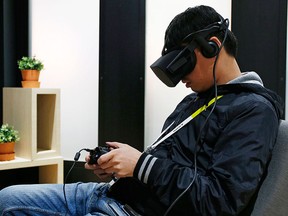 An attendee uses the Oculus Rift VR headset at the Oculus booth at CES International, Wednesday, Jan. 6, 2016, in Las Vegas. (AP Photo/John Locher)