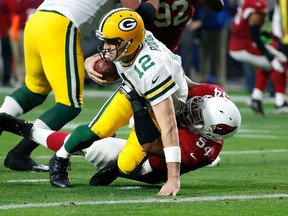In this Dec. 27, 2015, file photo, Green Bay Packers quarterback Aaron Rodgers (12) is sacked by Arizona Cardinals linebacker Dwight Freeney in Glendale, Ariz. (AP Photo/Ross D. Franklin, File)
