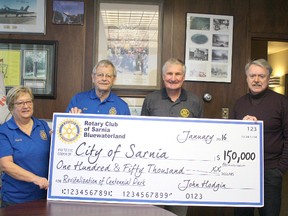 The Rotary Club of Sarnia Bluewaterland presents a $150,000 cheque towards two projects at Centennial Park on Friday January 15, 2016 in Sarnia, Ont. Funds will establish a new therapeutic garden and replace contaminated playground equipment. Pictured here are Rotary members Nancy Dease, John Hus and Henry Kulik, with Sarnia Mayor Mike Bradley. Barbara Simpson/Sarnia Observer/Postmedia Network