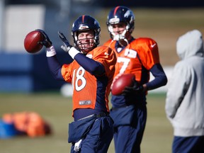 Denver Broncos quarterback Peyton Manning, front, throws a pass as backup quarterback Brock Osweiler looks on during practice Thursday, Jan. 14, 2016, in Englewood, Colo. (AP Photo/David Zalubowski)