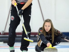 John Morris sweeps for teammate Rachel Homan in the Wall Grain Mixed Doubles Curling Classic at the Oshawa Curling Club in Oshawa, Ont. on Monday, November 16, 2015. THE CANADIAN PRESS/Frank Gunn